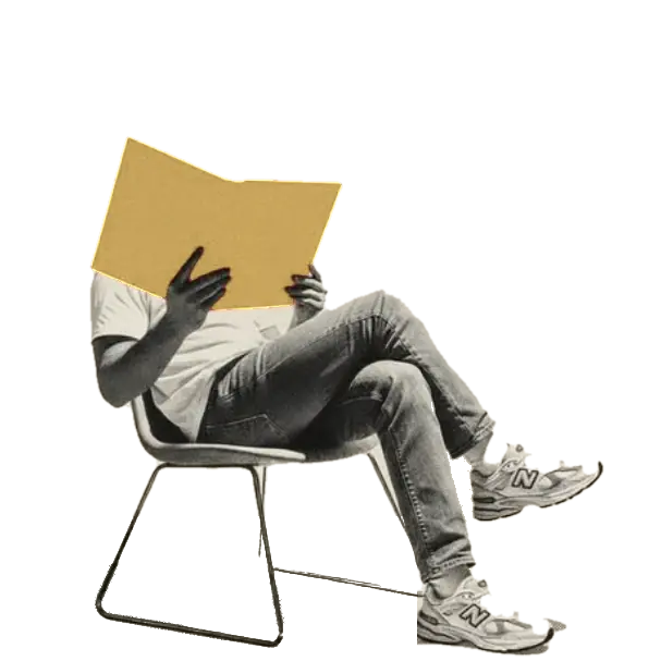 A man in a chair reading a book, his face hidden behind its pages
